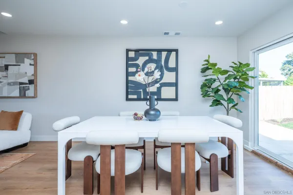 a kitchen with a sink a stove a dining table and chairs
