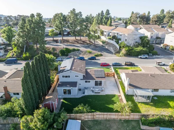 an aerial view of residential houses with outdoor space and swimming pool