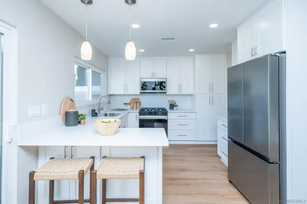 a front view of a house with a yard and fence