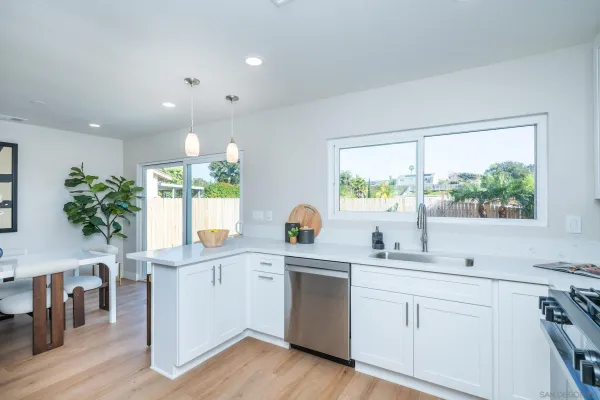 a living room with furniture a fireplace and a potted plant