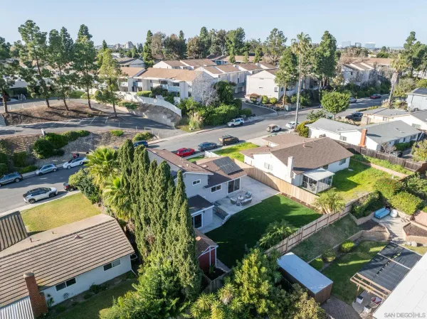 an aerial view of a house with garden space and swimming pool