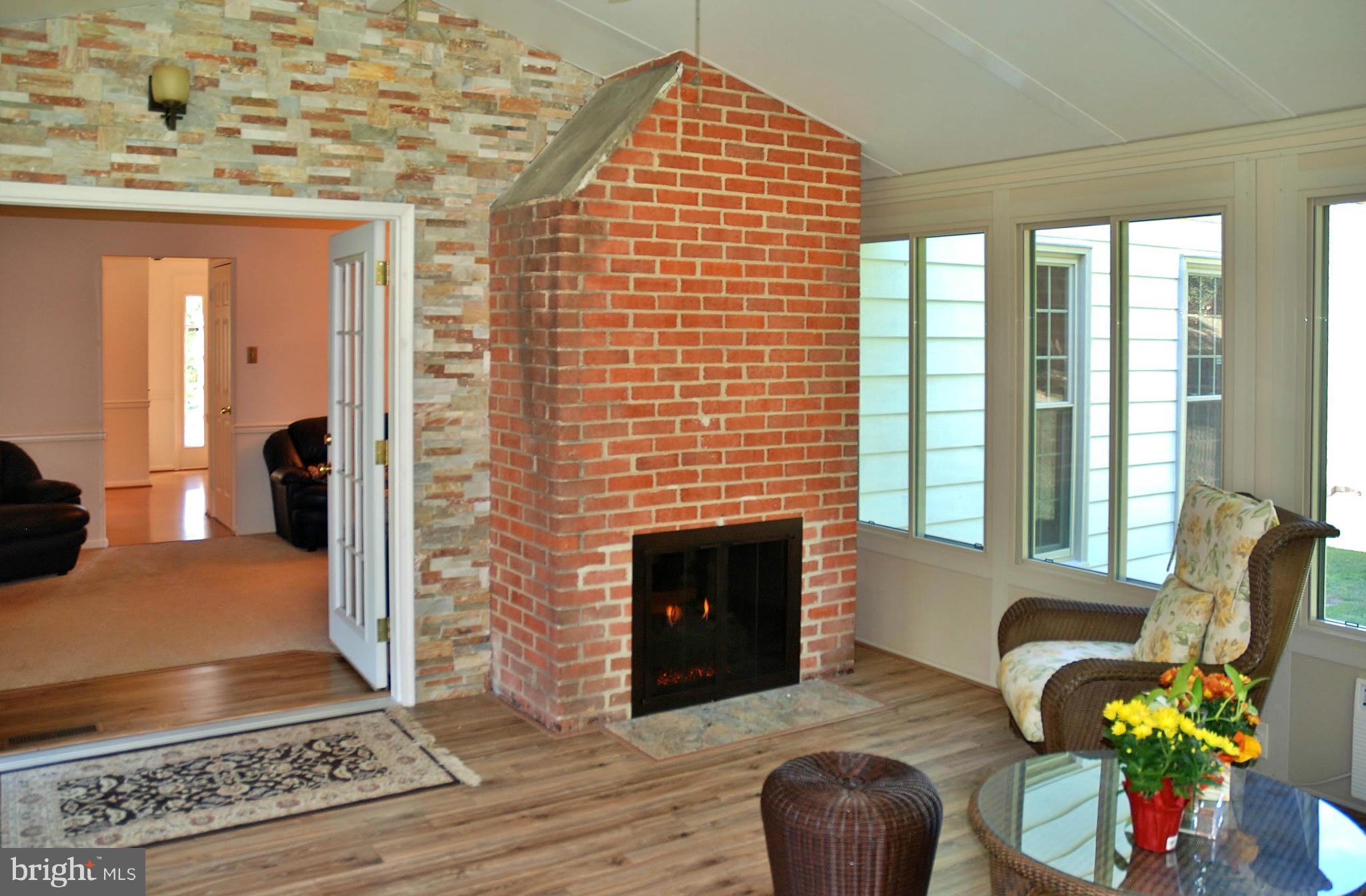 13809 Turnmore Road Silver Spring, MD 20906 - Photo 12 of 28 Sun room with Double Sided Gas Fireplace