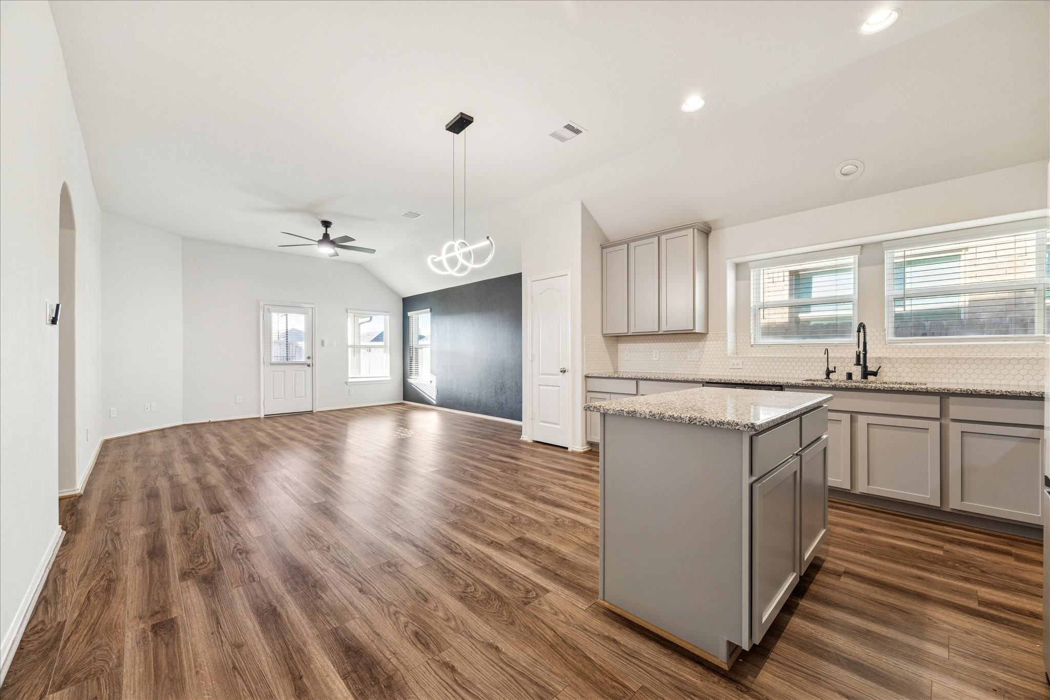 10318 Muir Bend Drive Rosharon, TX 77583 - Photo 5 of 10 a large kitchen with cabinets wooden floor and a sink