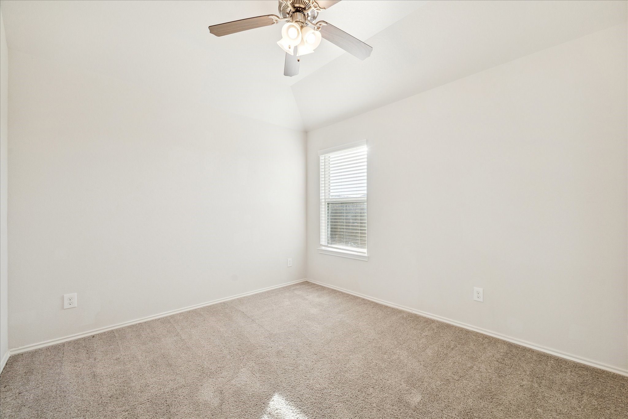 10318 Muir Bend Drive Rosharon, TX 77583 - Photo 6 of 10 an empty room with a chandelier fan and windows