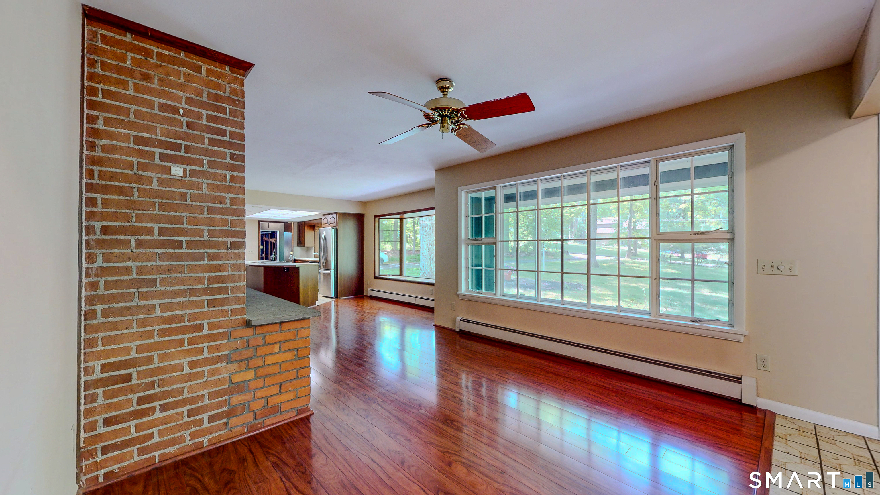 133 Chambers Road Danbury, CT 06811 - Photo 8 of 30 a view of a livingroom with wooden floor and a ceiling fan