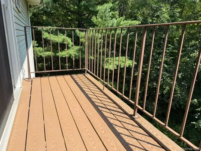 a view of balcony with floor to ceiling window