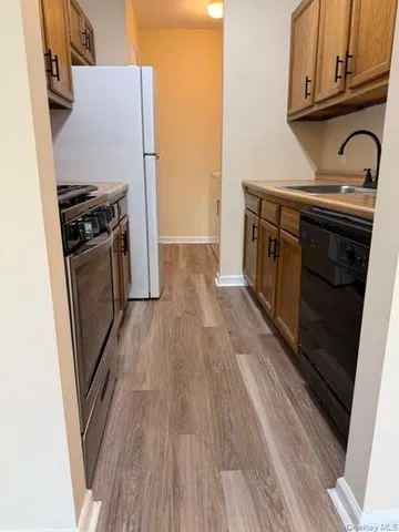 a stove top oven sitting inside of a kitchen