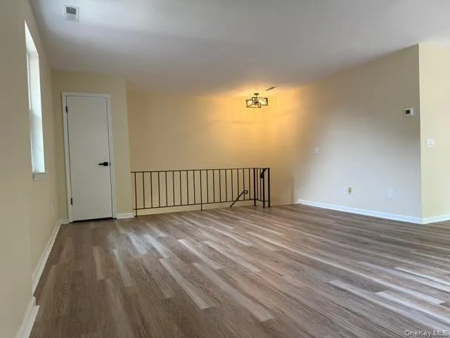 a view of a room with wooden floor