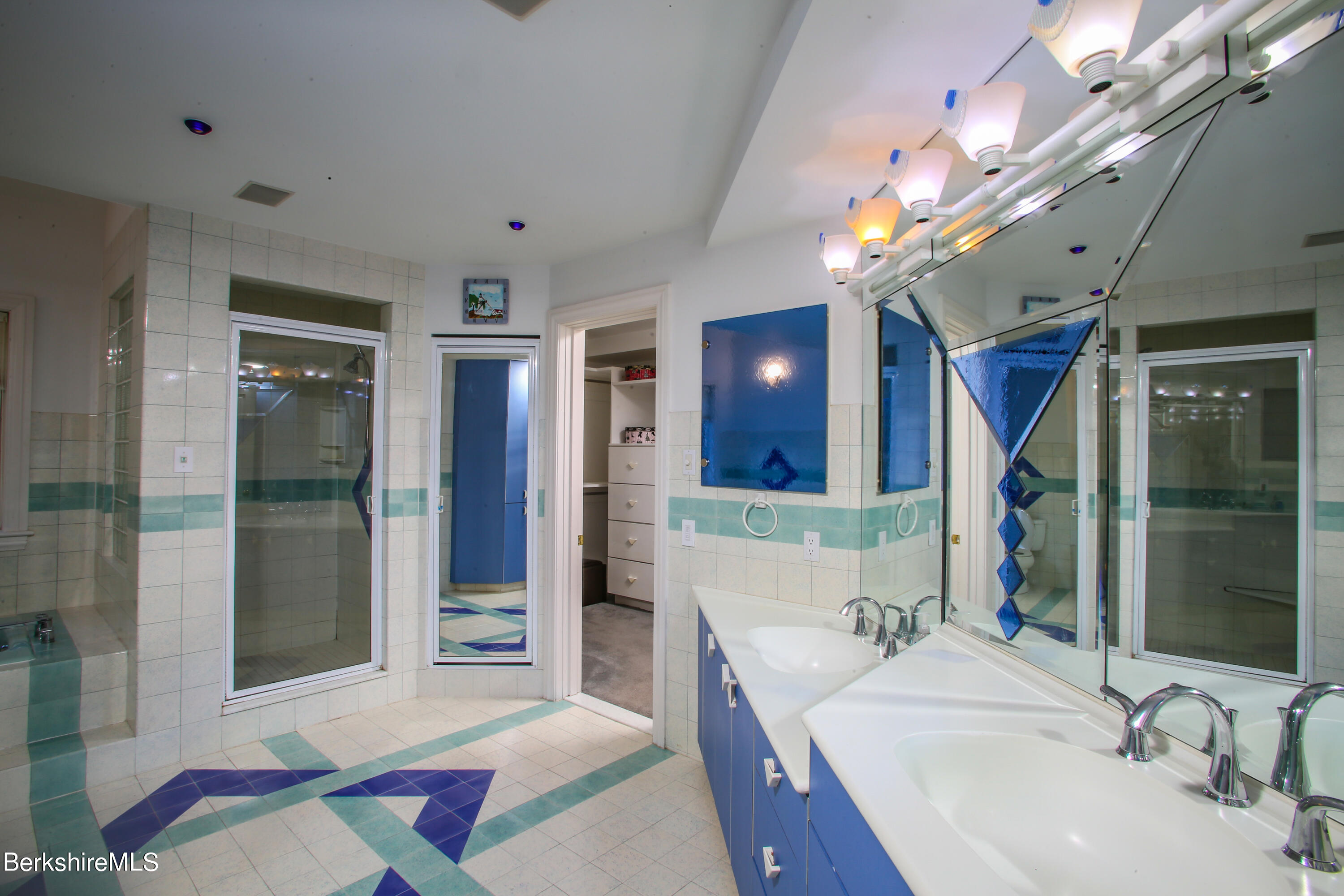 16 High Meadow Road Northampton, MA 01062 - Photo 19 of 49 a en suite bathroom with a sink a large mirror and shower