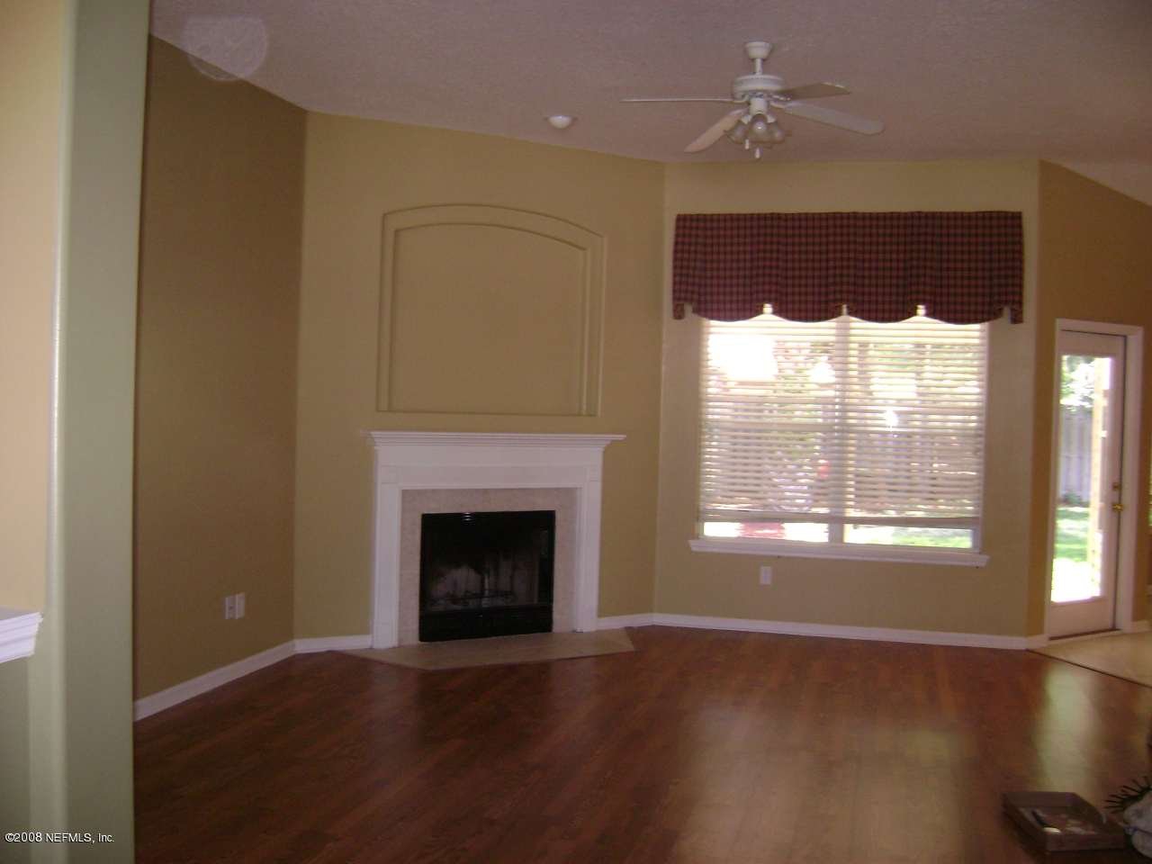 2451 Mallory Hills Road Jacksonville, FL 32221 - Photo 4 of 11 a view of an empty room with wooden floor and a window