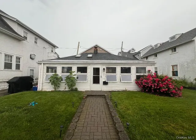 a front view of a house with a garden