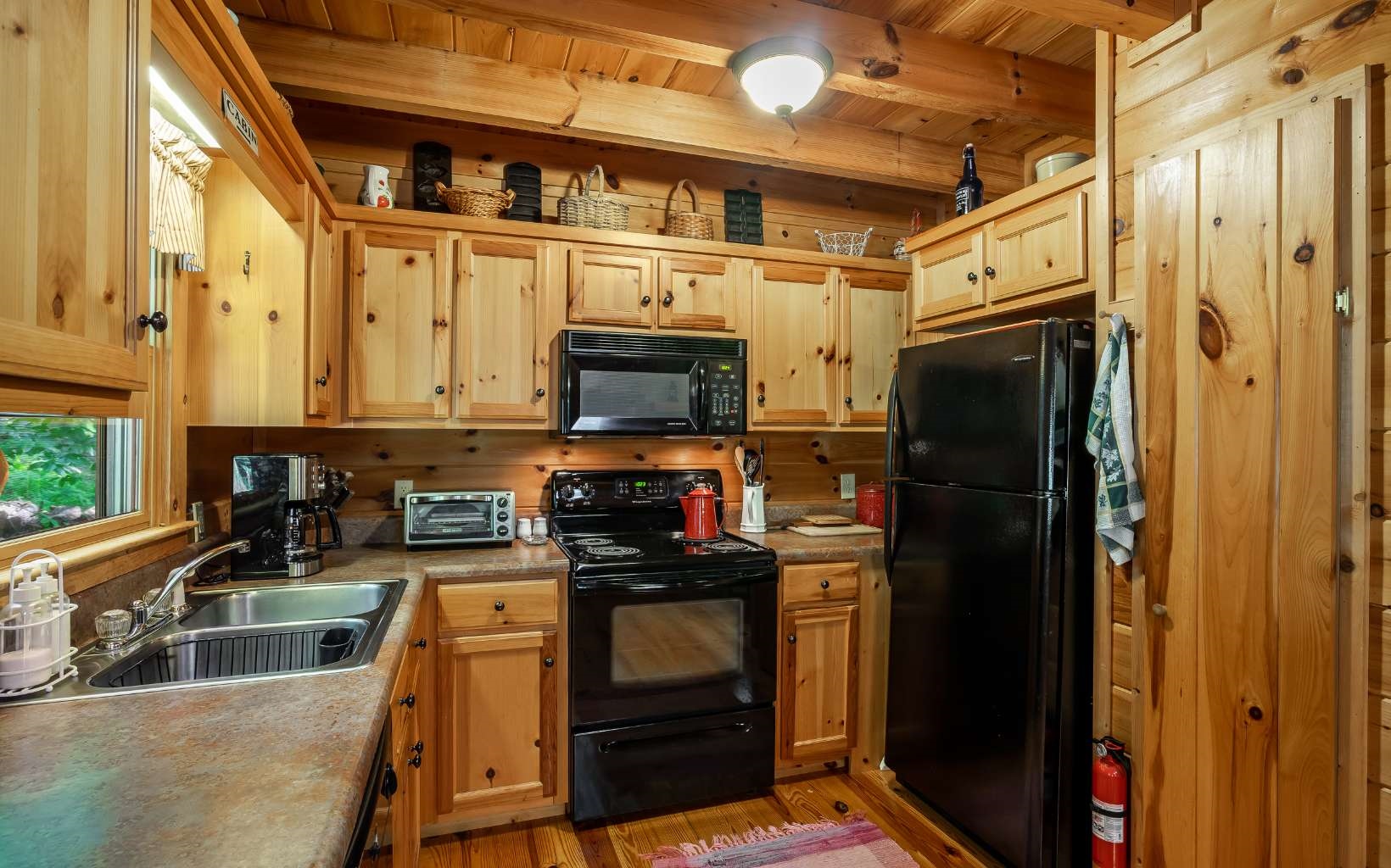 282 Papa Bear Path Cherry Log, GA 30522 - Photo 5 of 33 a kitchen with stainless steel appliances granite countertop a refrigerator a stove and a sink with wooden floor