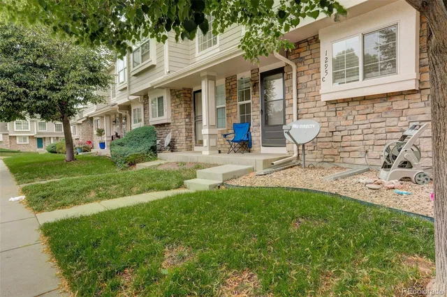 a front view of a house with garden and patio