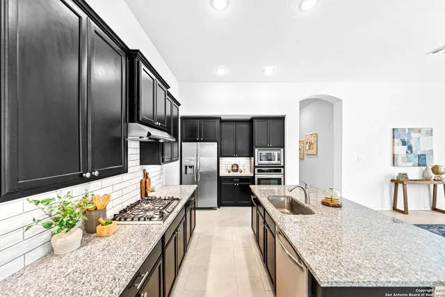 a dining room with furniture potted plants and wooden floor