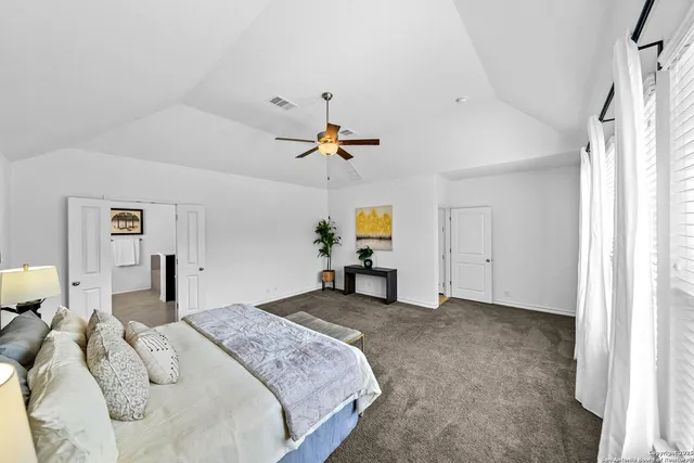 a bedroom with a bed and a potted plant