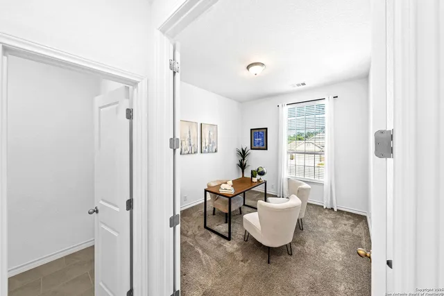 a bedroom with a bed couch and a window