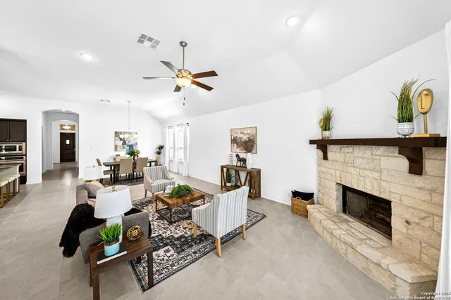 a living room with furniture and a fireplace