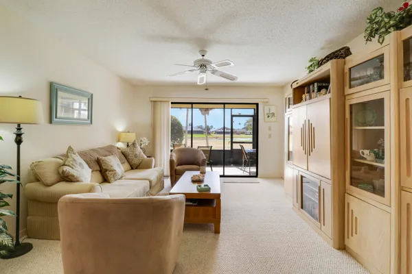 a living room with furniture and large windows