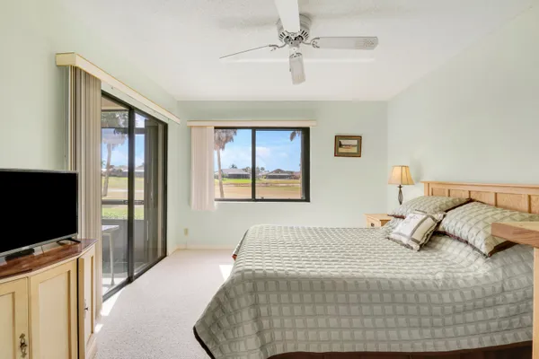 a bedroom with a large bed and a flat screen tv