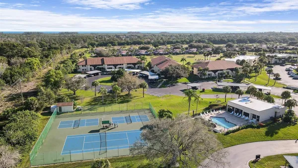 an aerial view of residential houses with outdoor space