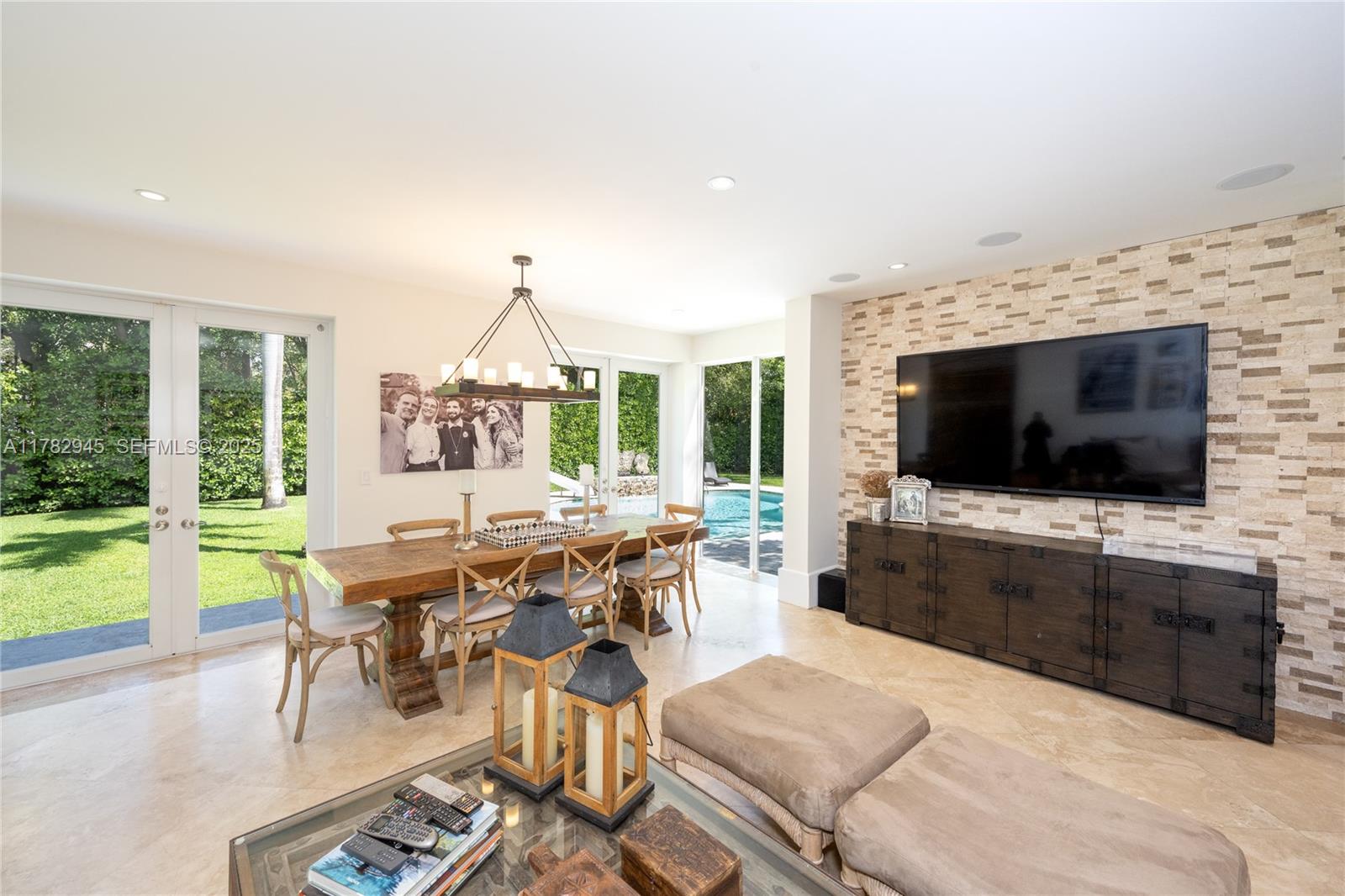 31 Island Drive Key Biscayne, FL 33149 - Photo 13 of 26 a living room with furniture a flat screen tv and a large window