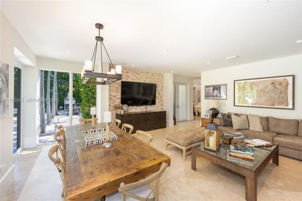 a kitchen with a stove a sink a center island and cabinets