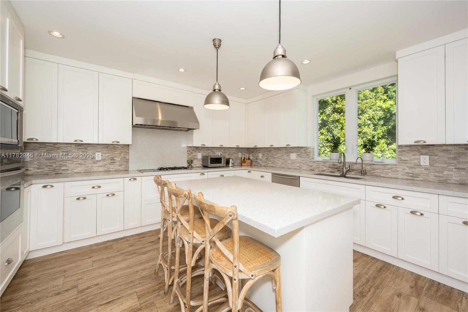 31 Island Drive Key Biscayne, FL 33149 - Photo 15 of 26 a kitchen with a stove a sink a center island and cabinets