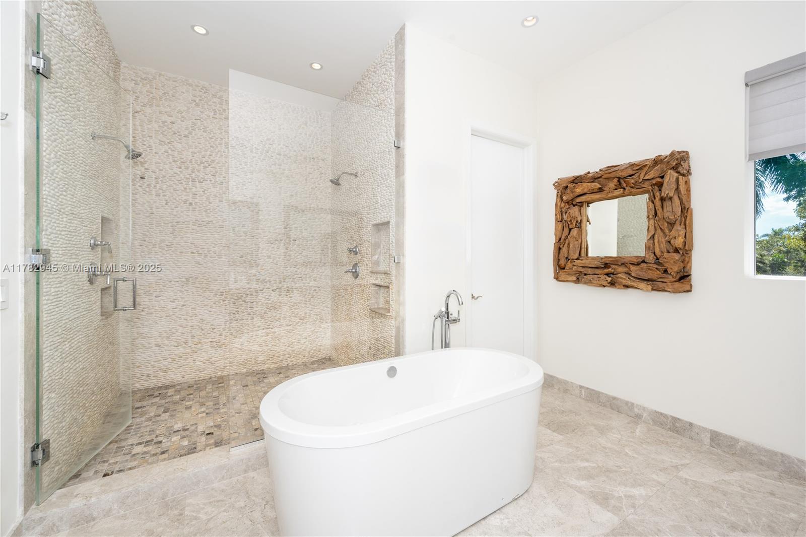31 Island Drive Key Biscayne, FL 33149 - Photo 21 of 26 a white bath tub sitting next to a white sink and a shower
