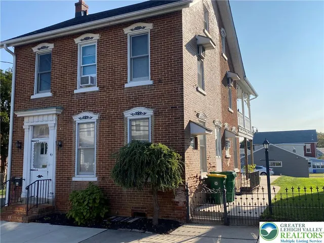 a front view of a building with potted plants