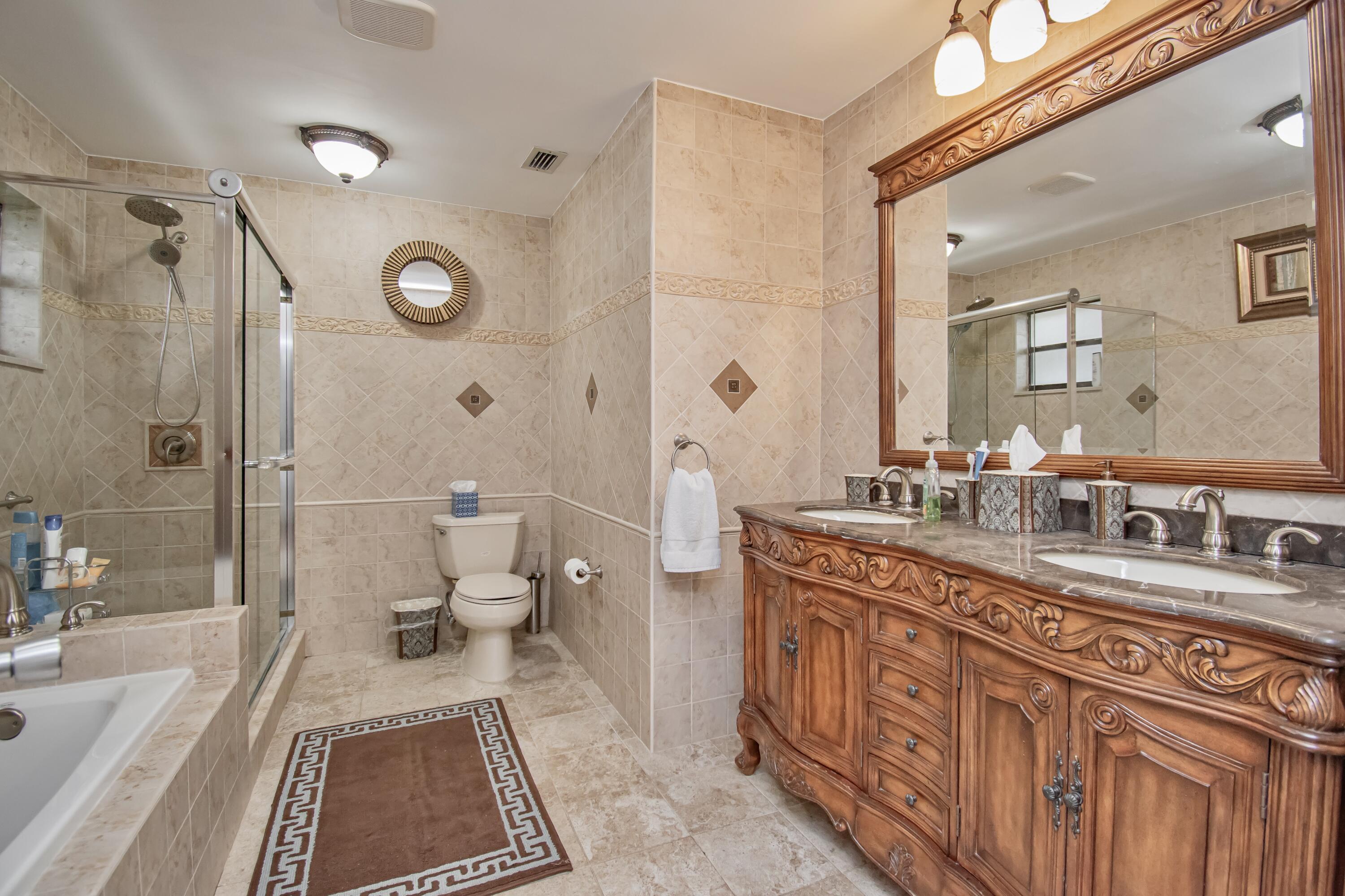 7838 Cypress Crescent Boca Raton, FL 33433 - Photo 14 of 24 a spacious bathroom with double vanity sink a mirror and a shower