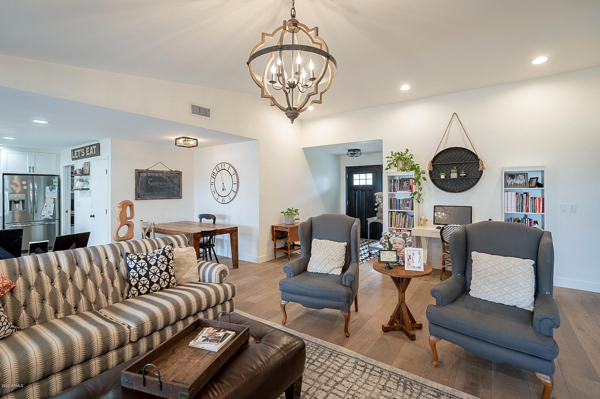 6109 East Spring Road Scottsdale, AZ 85254 - Photo 8 of 38 a living room with furniture a clock and a large mirror