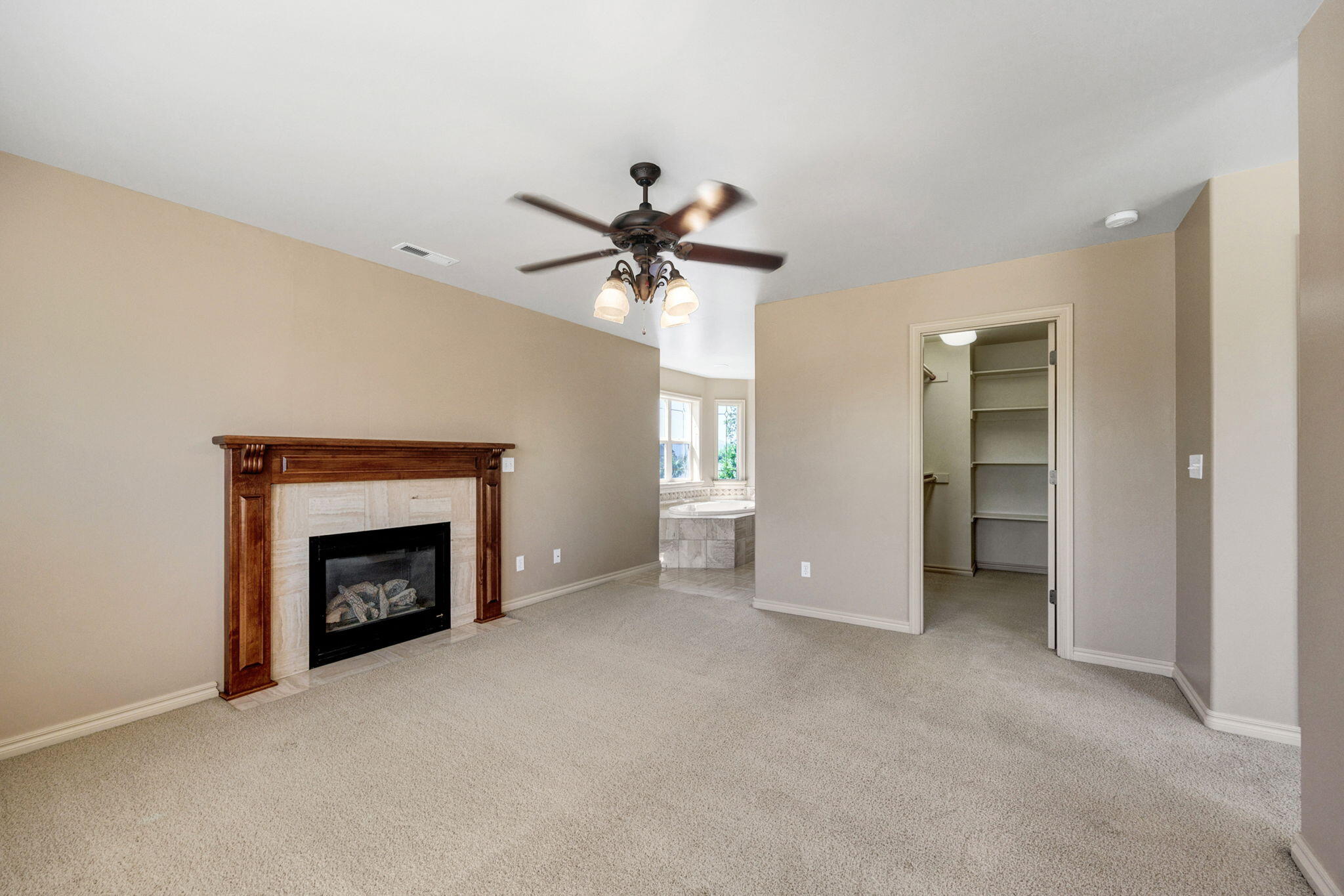 523 Ridgeway Avenue Central Point, OR 97502 - Photo 38 of 68 an empty room with chandelier fan and fireplace