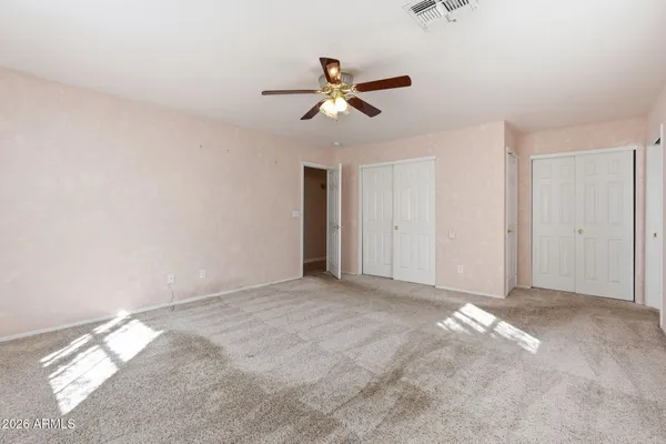 a view of empty room with ceiling fan