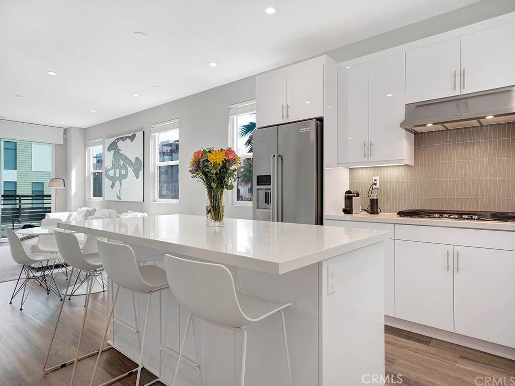 604 Malibu Costa Mesa, CA 92627 - Photo 11 of 40 a kitchen with stainless steel appliances granite countertop a refrigerator and a sink