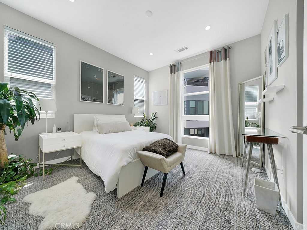 604 Malibu Costa Mesa, CA 92627 - Photo 19 of 40 a spacious bedroom with a bed and a chair