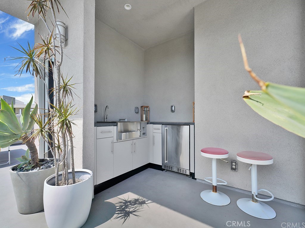 604 Malibu Costa Mesa, CA 92627 - Photo 30 of 40 a living room with furniture and a potted plant