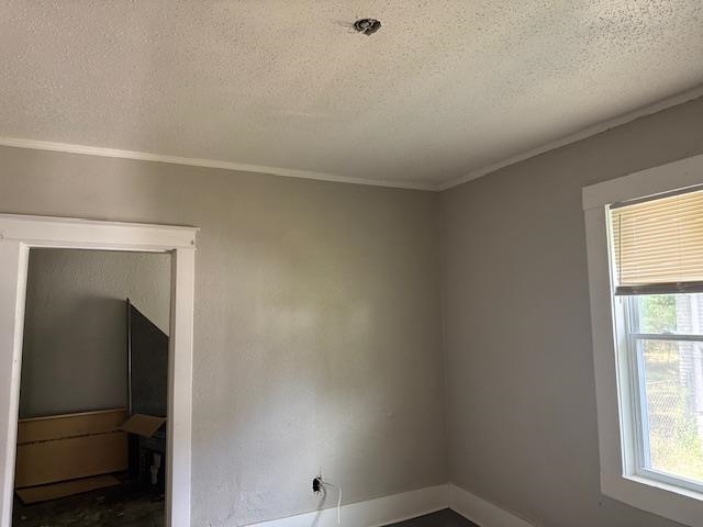 1559 Harrison Street Memphis, TN 38108 - Photo 7 of 11 Spare room featuring crown molding and a textured ceiling