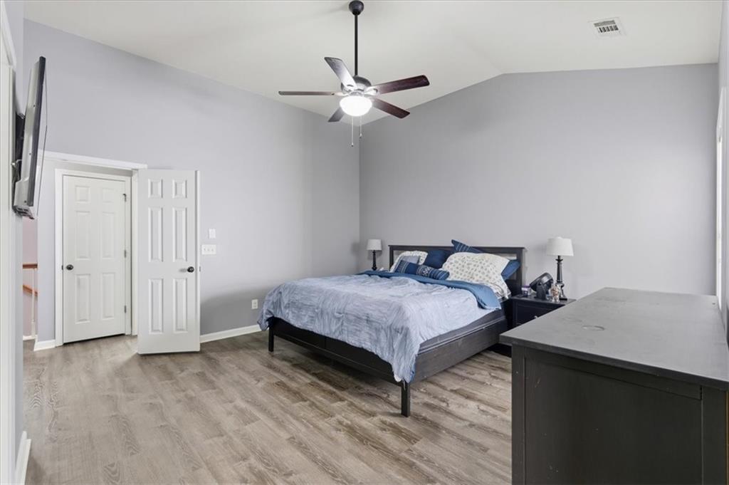 4349 Kousa Road, Unit 4 Austell, GA 30106 - Photo 14 of 43 a bedroom with a bed and a chandelier