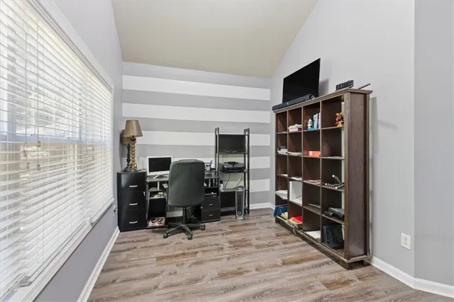 a view of a livingroom with workspace and a window