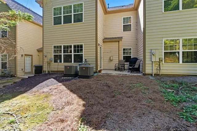 a view of a house with backyard and sitting area