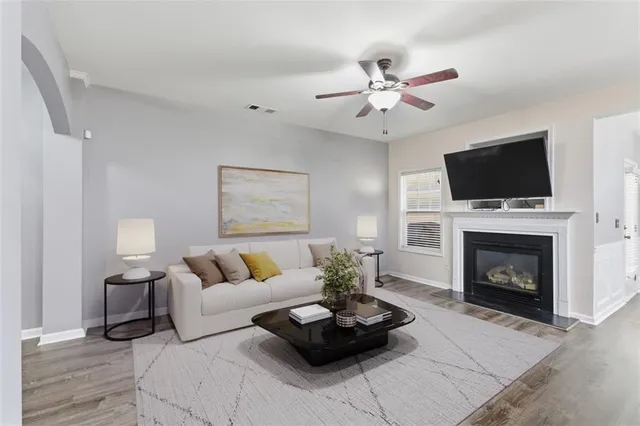 a living room with furniture a fireplace and a flat screen tv