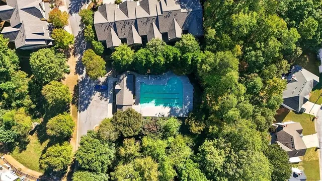 an aerial view of a house with a yard and garden