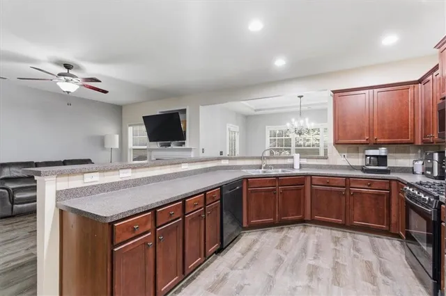 a kitchen with stainless steel appliances granite countertop a sink and cabinets