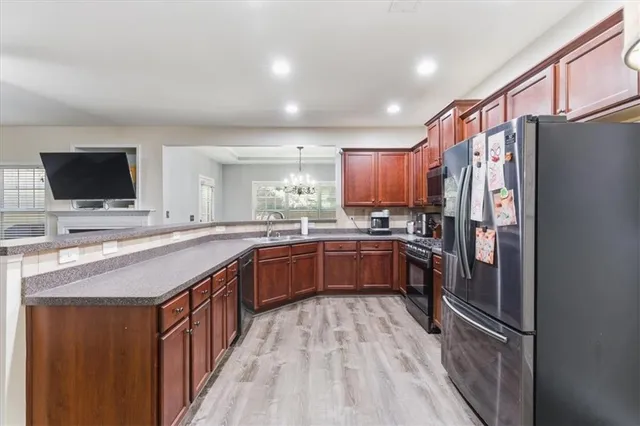 a kitchen with stainless steel appliances granite countertop a refrigerator and a stove top oven