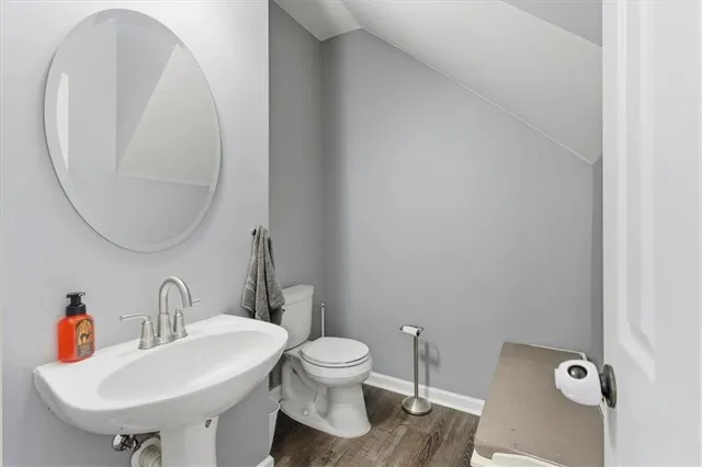 a bathroom with a toilet a sink and a mirror