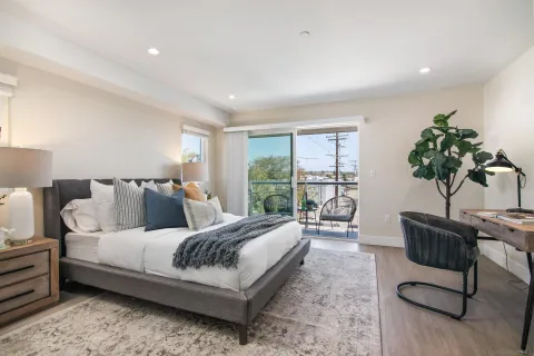 a bedroom with bed and a large window