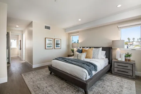 a bedroom with a bed and a night stand