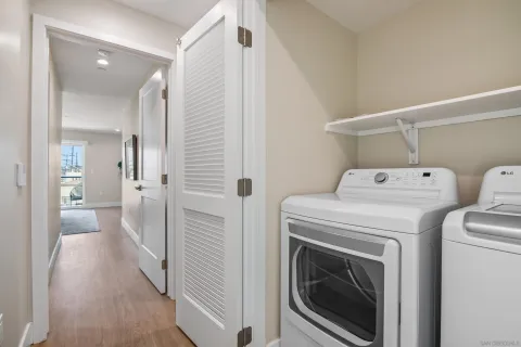 a view of a storage & utility room with a washer dryer