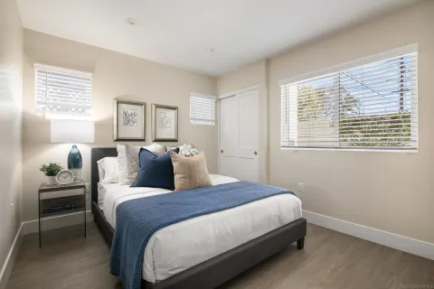 a bedroom with a large bed and a window