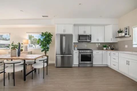 a kitchen with a white stove top oven and refrigerator